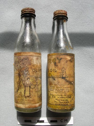 Olive bottle sold by R R Johnstone of Dornoch