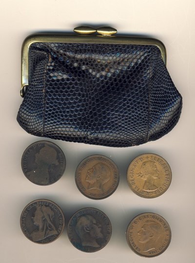 Various 1d coins in a black purse
