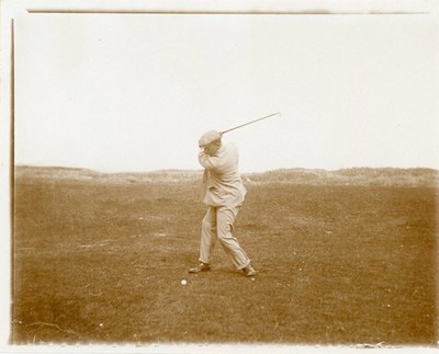 Early photograph of gentleman teeing off