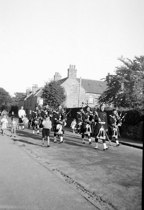 Dornoch Pipe Band accompanied by children