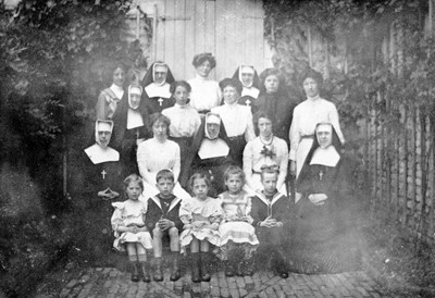 A group of nuns, other ladies and five children