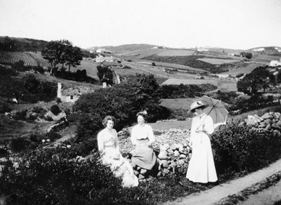 Three women with farm landscape