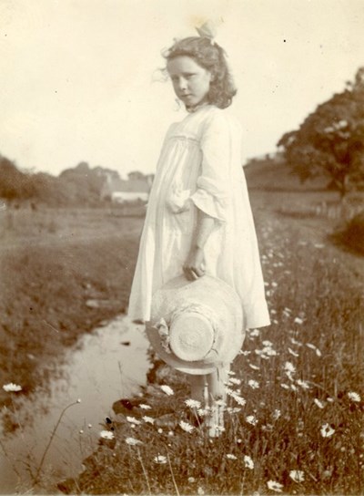 Young girl standing in a flower meadow