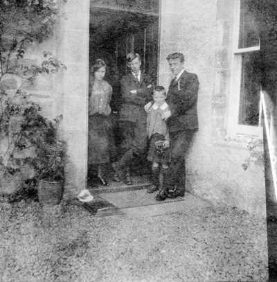 Family group standing in a doorway