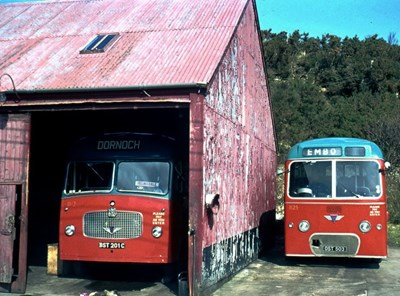 Two single deck buses at Dornoch Bus Garage