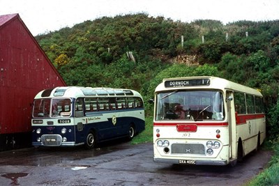 Two buses in different livery at Dornoch garage