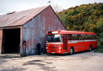 Single deck buses in red & white livery at Dornoch