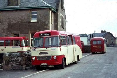 Mail buses in red and white livery at Lairg Post O