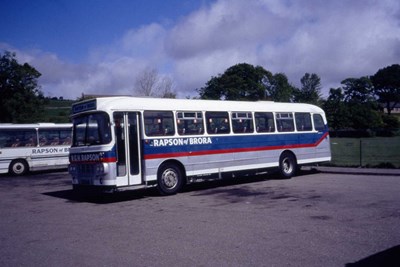 Livery of R G H Rapson coaches parked at Golspie High School
