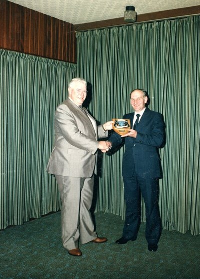 John Jappy receiving shield presented on retiremen