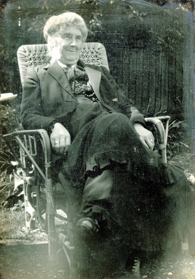 Elderly lady sitting in wicker chair
