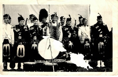 Monochrome group photograph of Dornoch Pipe Band