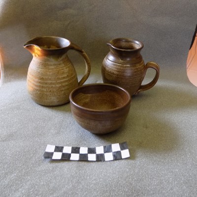 Two milk jugs and a sugar bowl from Dornoch Pottery