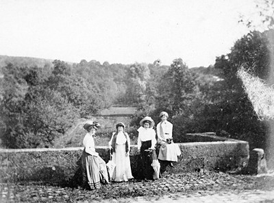 Four ladies of the Grant family at a bridge parapet