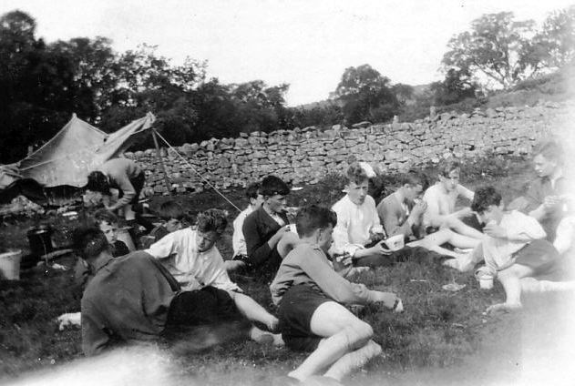 Scouts grouped at tea at scout camp