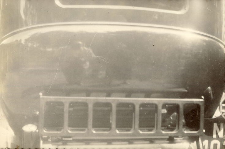 Reflection of Man and Woman (prob. Mr. and Mrs. Hardie) in car