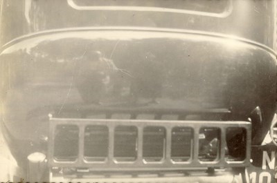 Reflection of Man and Woman (prob. Mr. and Mrs. Hardie) in car
