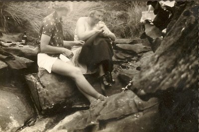 Two women having a beach picnic