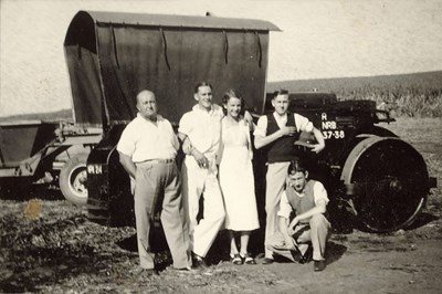 Thomas Hardie, together with three young men and a young woman, in front of a steam roller/tractor