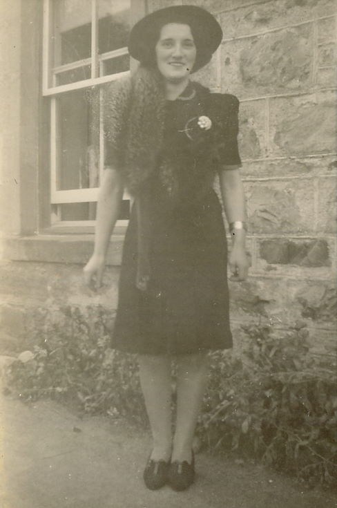Woman standing outside a house ~ possibly 