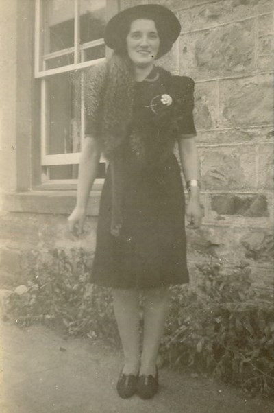Woman standing outside a house ~ possibly 