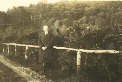 Album 6 Man standing against a single-rail fence