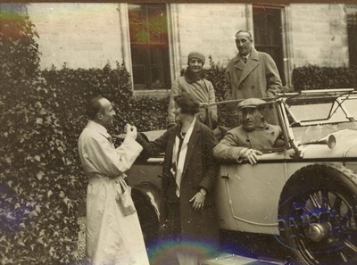 Group of five people and car at time of 1928 pageant