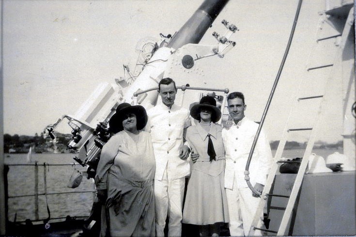 Two couples in front of a naval gun