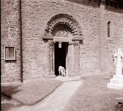 Carved Church Entrance with dog looking inside