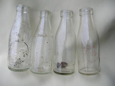 Set of four glass milk bottles