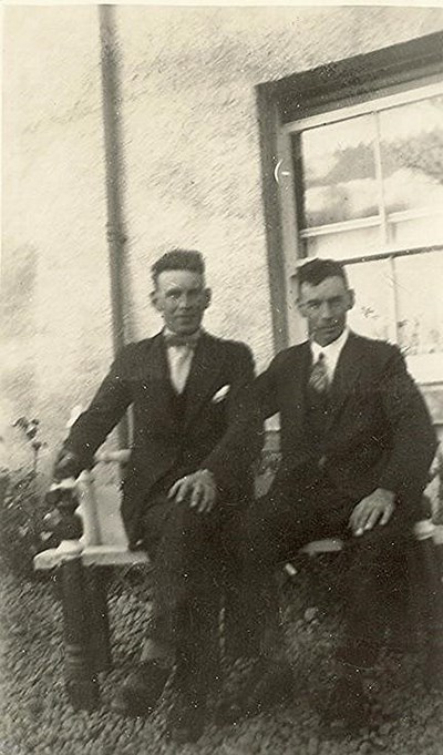 Two men seated at the front of 'Three Trees'