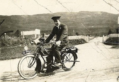 Railway worker seated on a motorbike