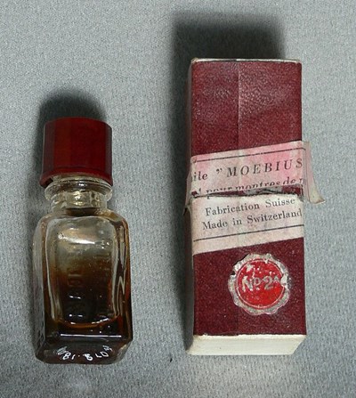 Box with bottle of watch oil